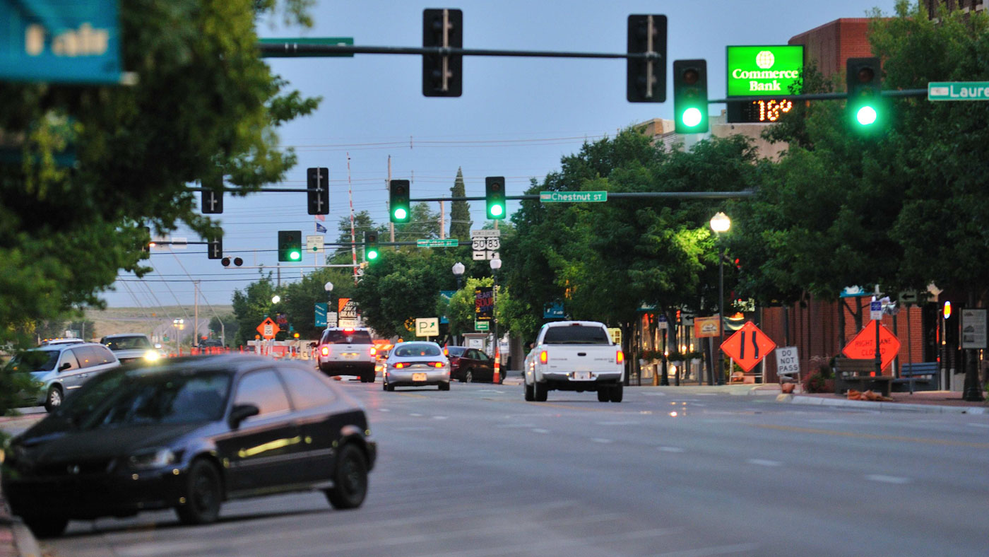 cars and green traffic lights on main street